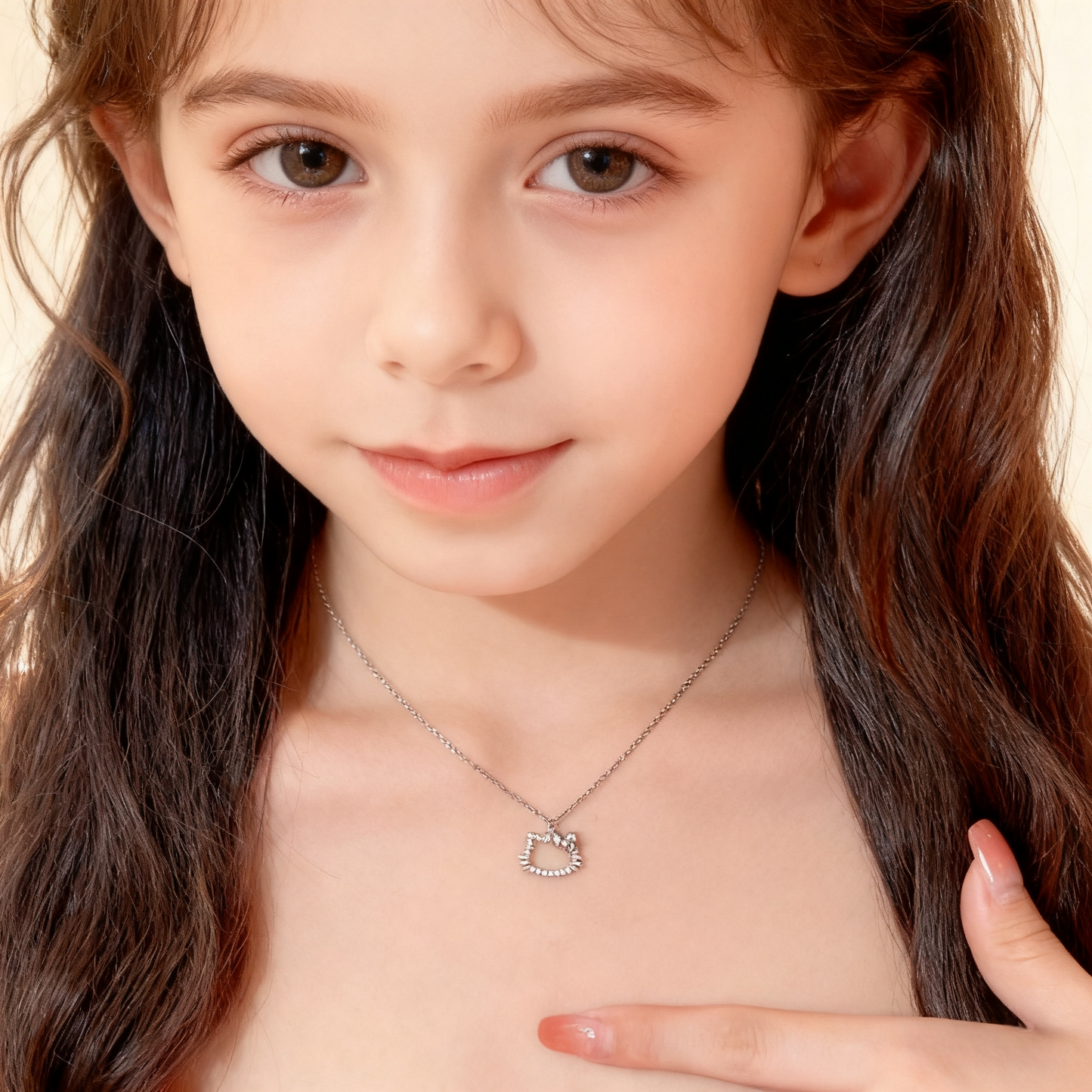 Young girl wearing a silver necklace with a heart-shaped pendant on a beige background