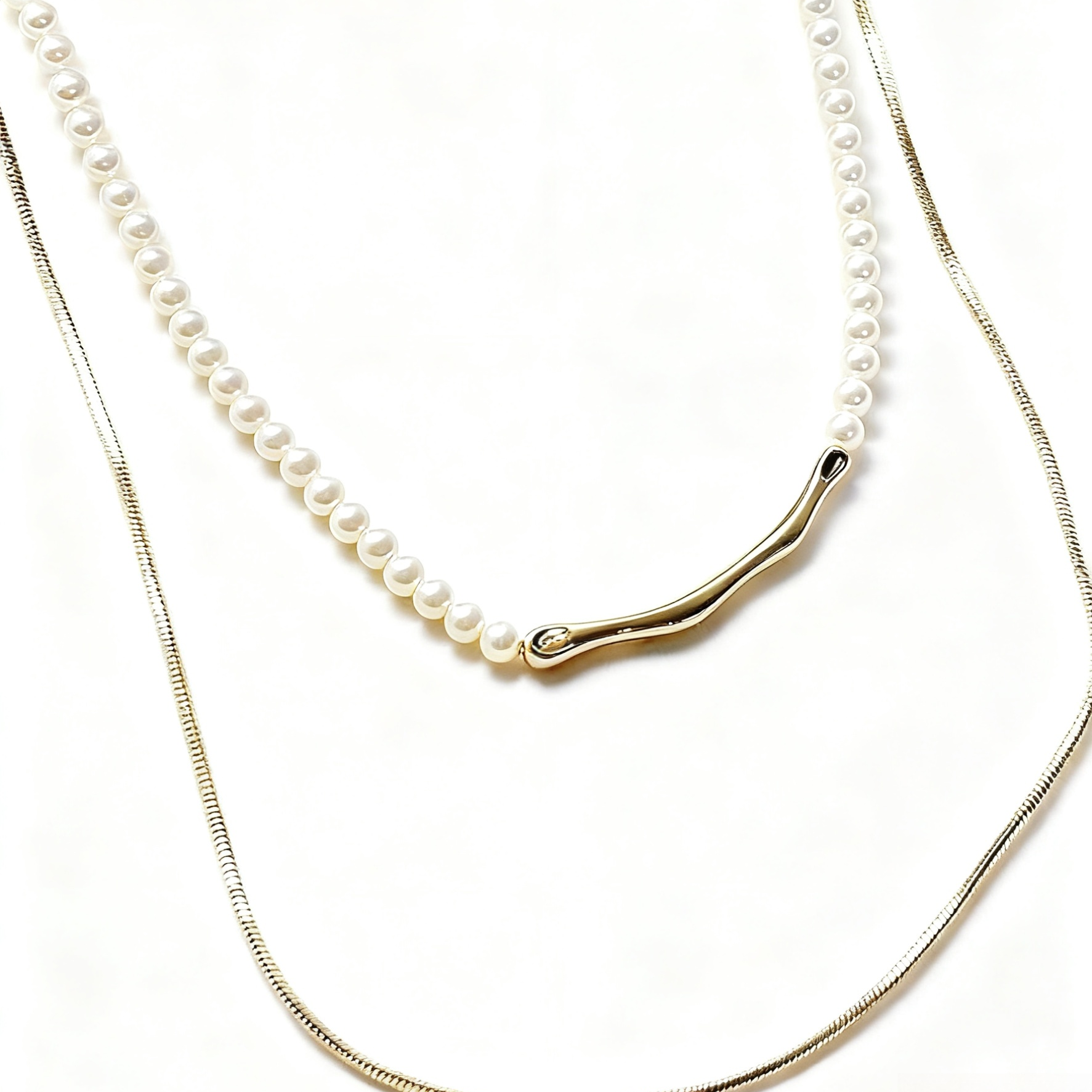 Two pearl necklaces with gold clasps on a white background