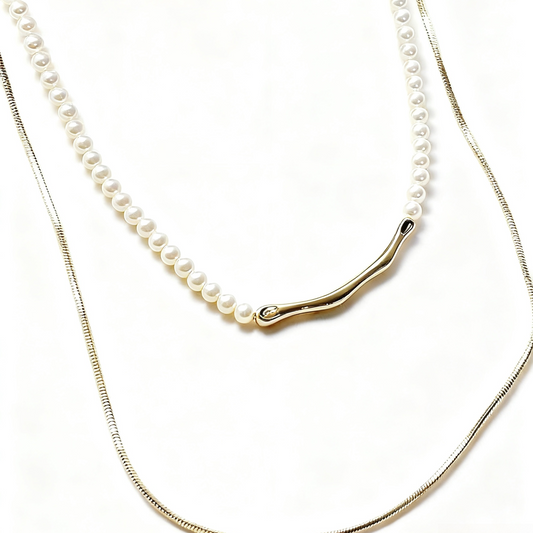 Two pearl necklaces with gold clasps on a white background