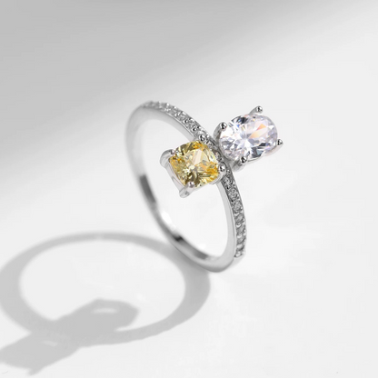 Silver ring with two gemstones on a white background