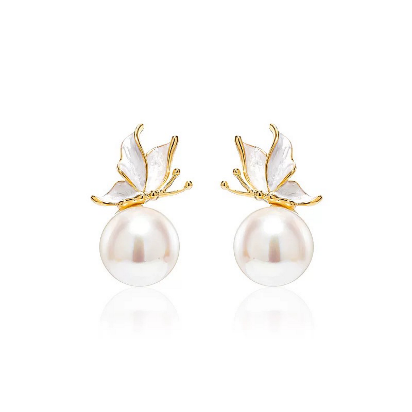 Pearl earrings with gold butterfly accents on a white background