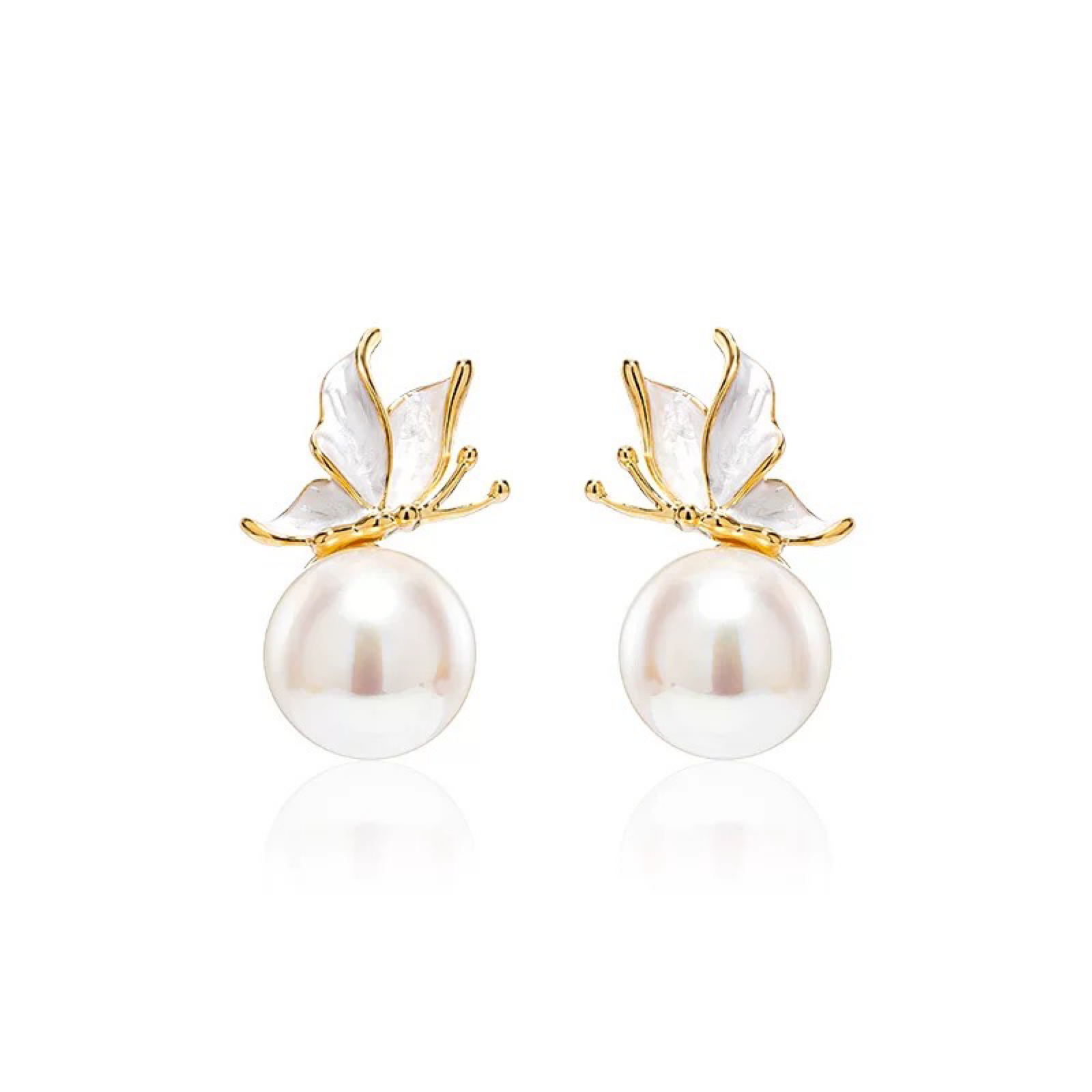 Pearl earrings with gold butterfly accents on a white background