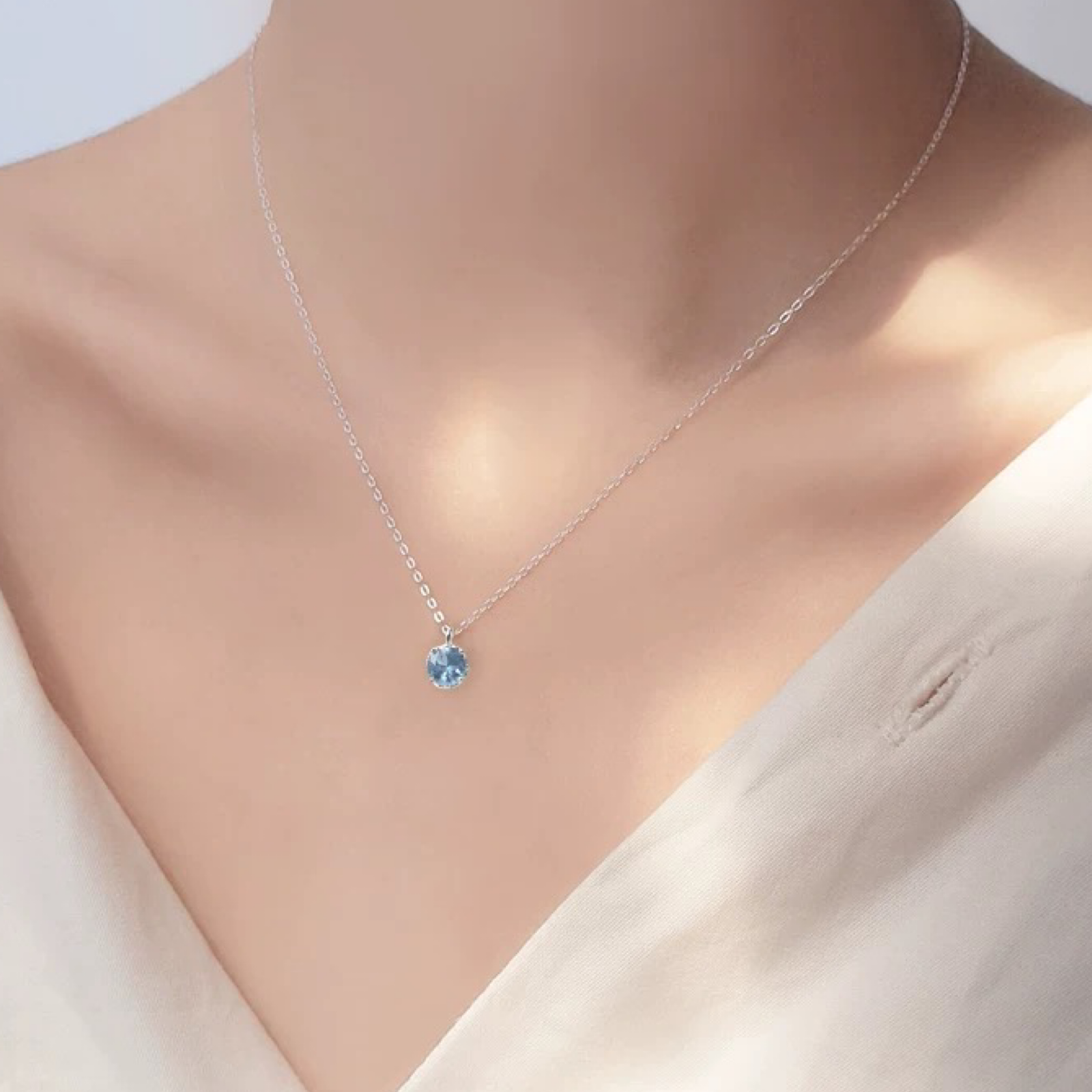 Necklace with a blue pendant on a mannequin