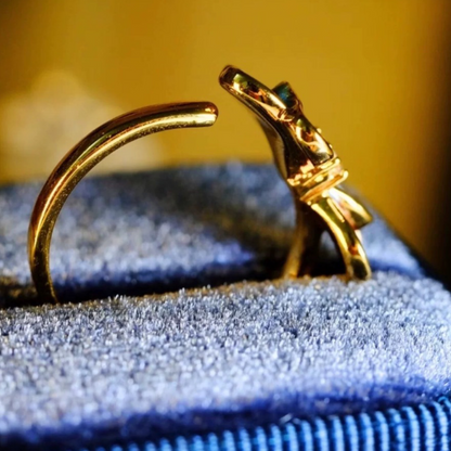 Gold ring with a blue fabric background