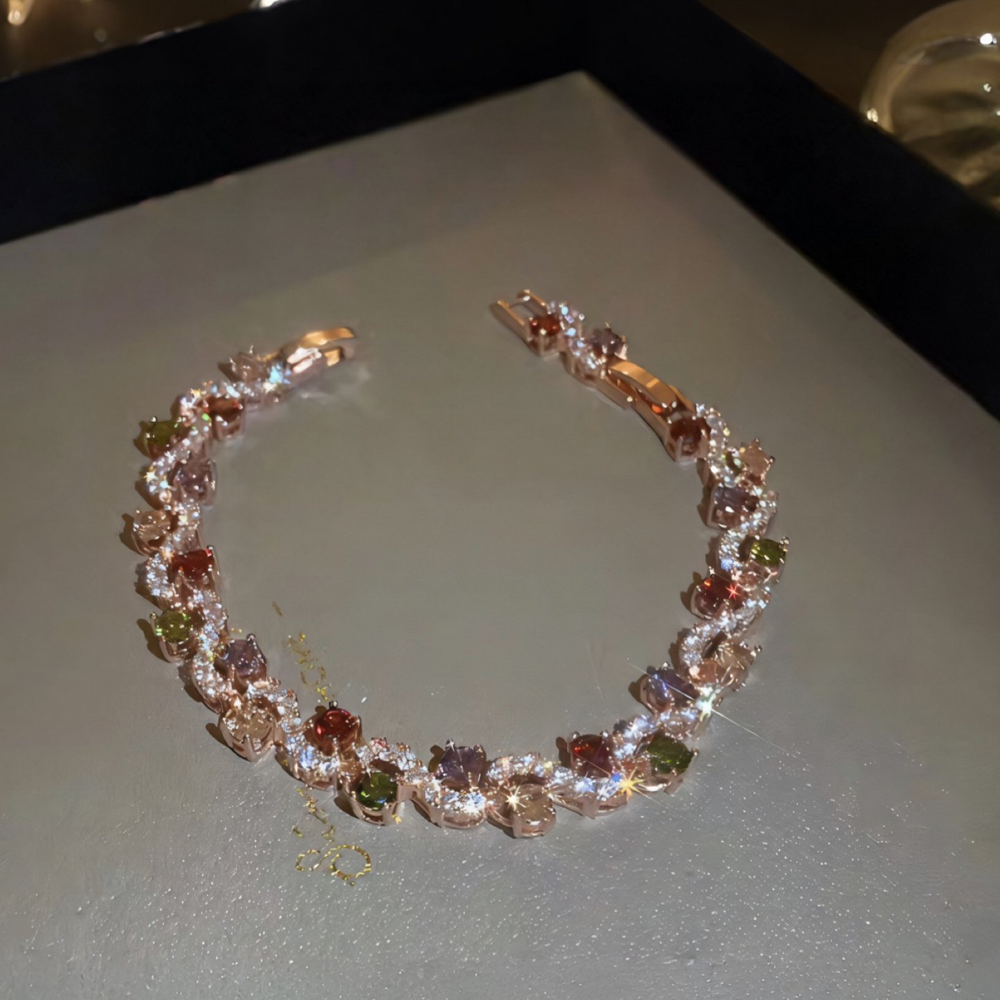 Jewelry box with a decorative headband featuring gemstones on a reflective surface.