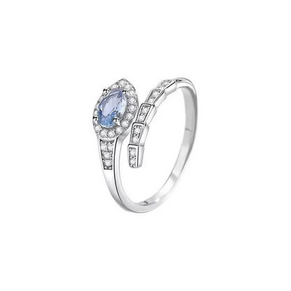 Silver ring with a pear-shaped blue gemstone on a white background