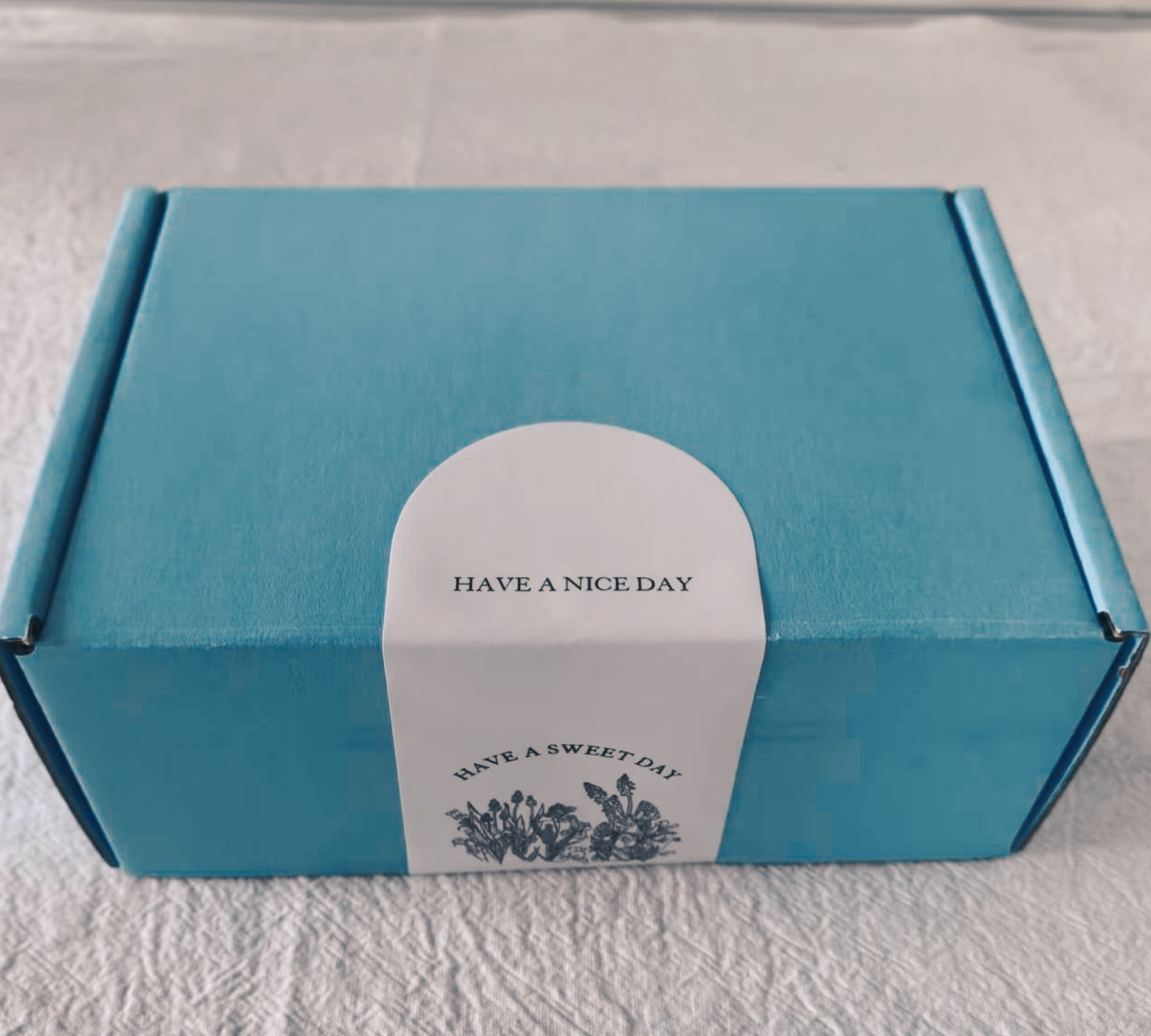 Blue box with a white label on a light gray background
