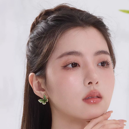 Woman wearing Emerald Green Crystal Butterfly Earrings Clip-On Stud Women Summer 2025 on left ear